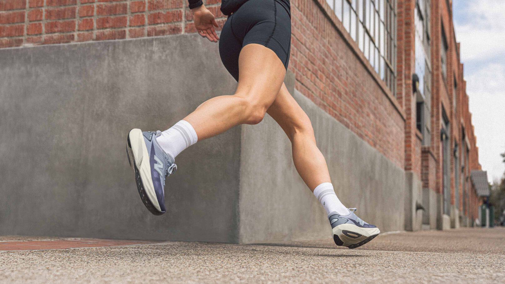 Knee down action shot of woman running